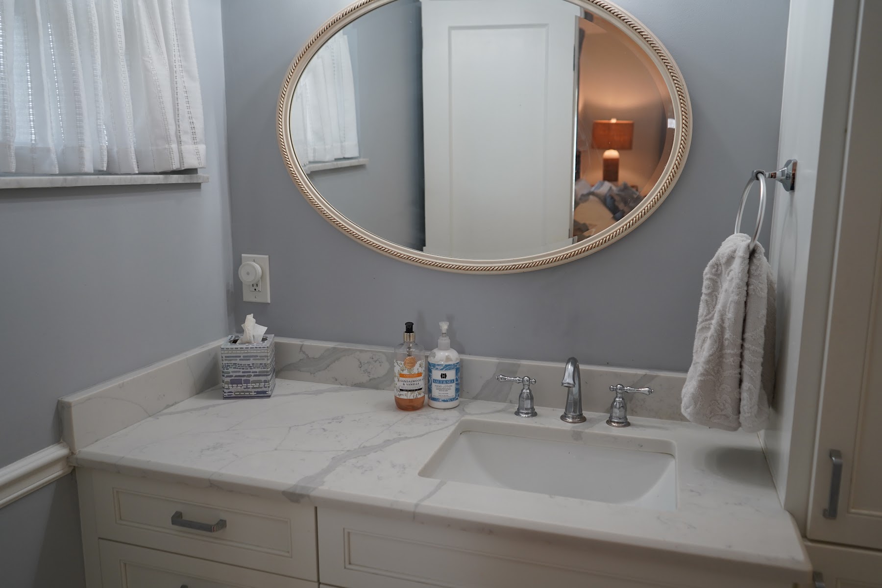 Bathroom vanity and round mirror