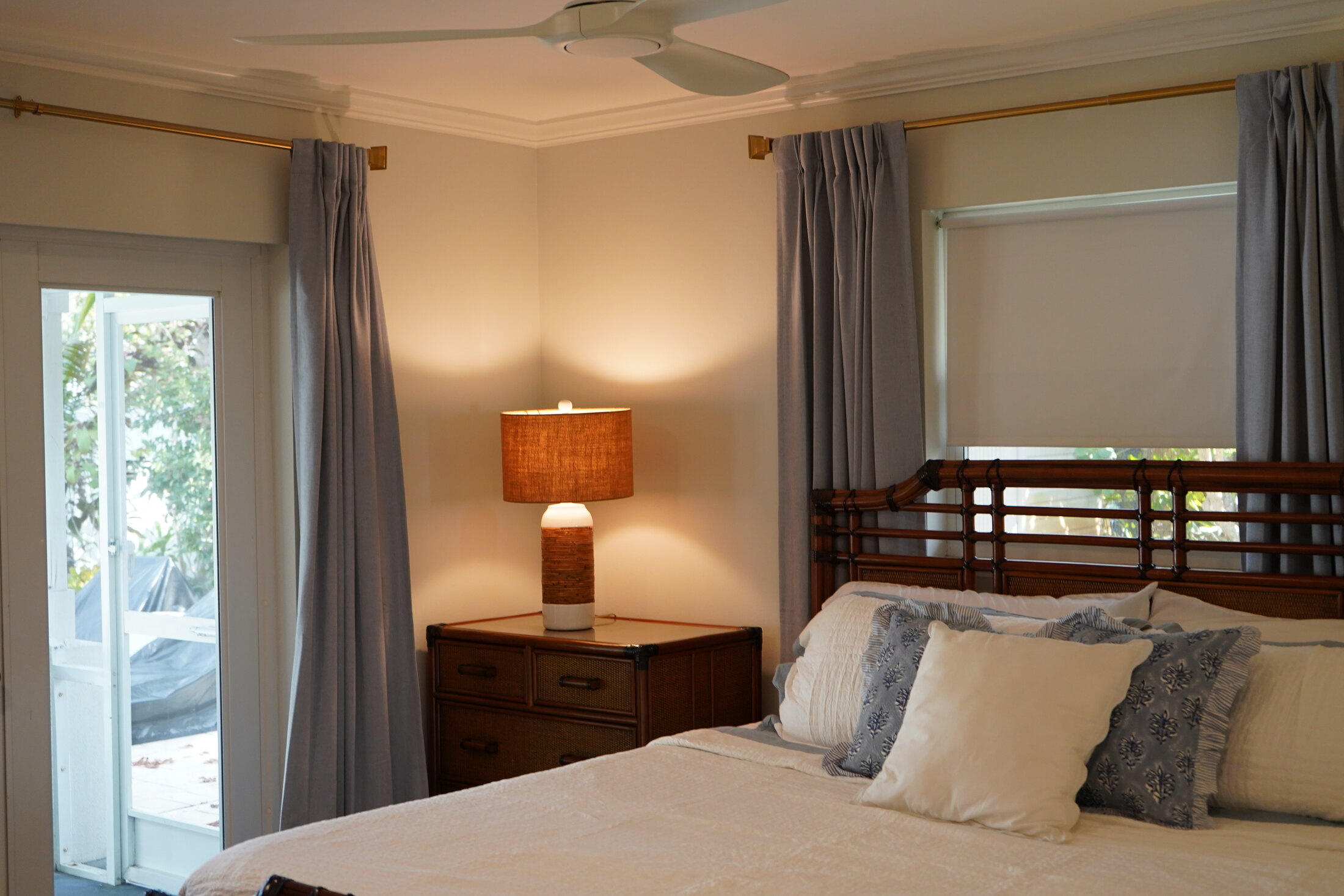 Inviting bedroom with layered bedding and tropical views